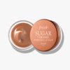 Fresh Sugar Hydrating Lip Balm in Caramel flavor, housed in a round jar for smooth, nourished lips