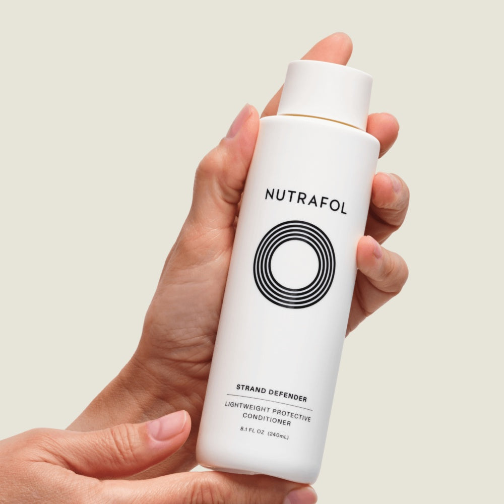 Nutrafol Strand Defender Lightweight Protective Conditioner bottle for hair strengthening and protection.