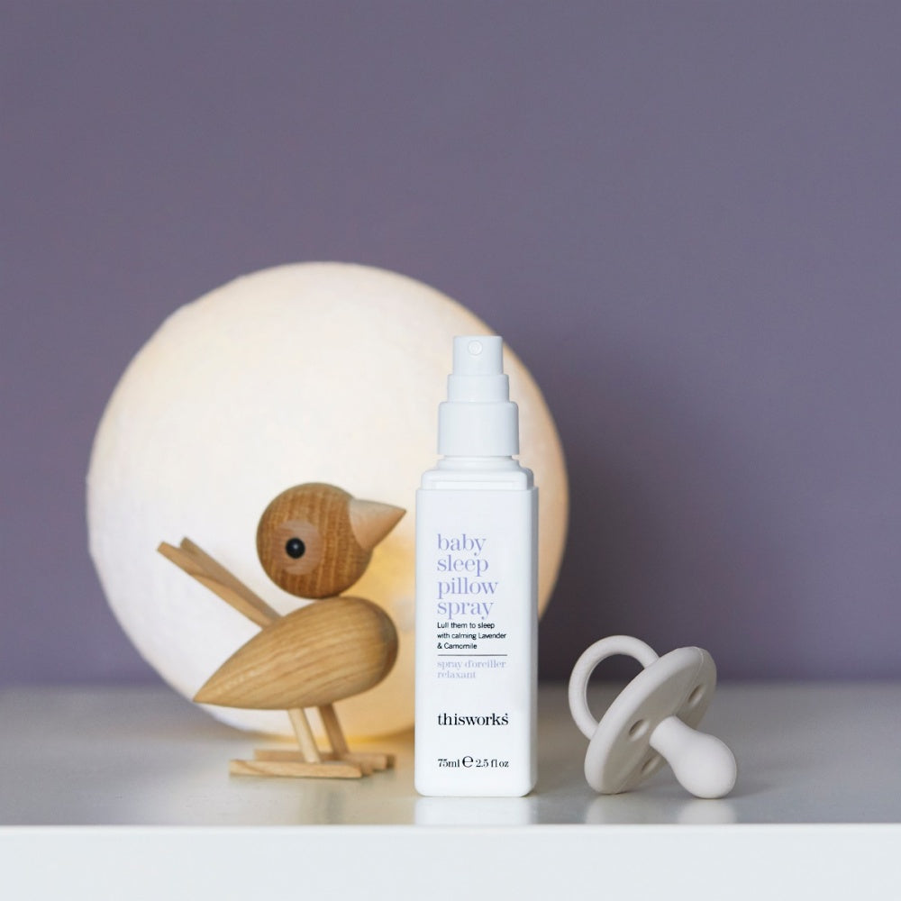 This Works Baby Sleep Pillow Spray 75ml bottle displayed in a cozy bedtime setting.