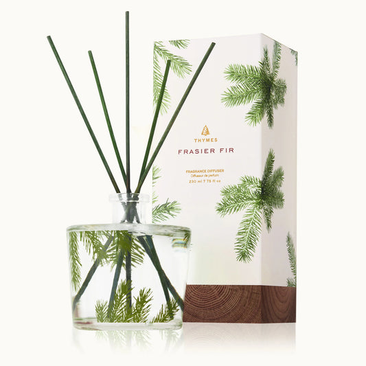 Thymes Frasier Fir Pine Needle Reed Diffuser 7.75 OZ in elegant glass bottle with natural reed sticks for fresh pine scent home fragrance.